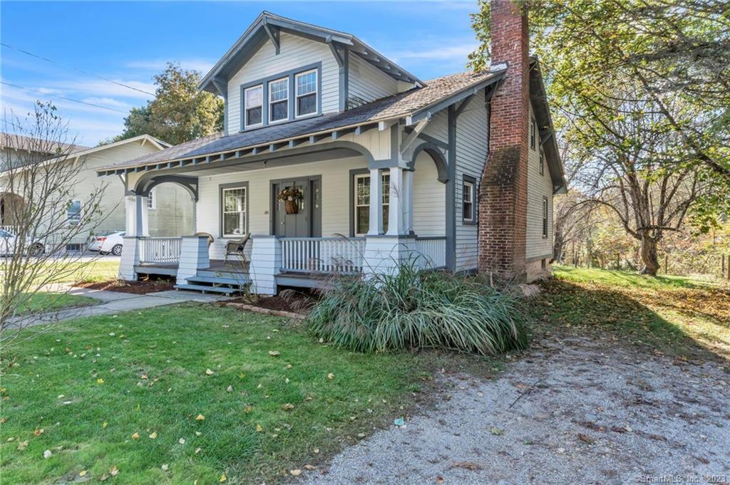 a front view of a house with yard and seating space