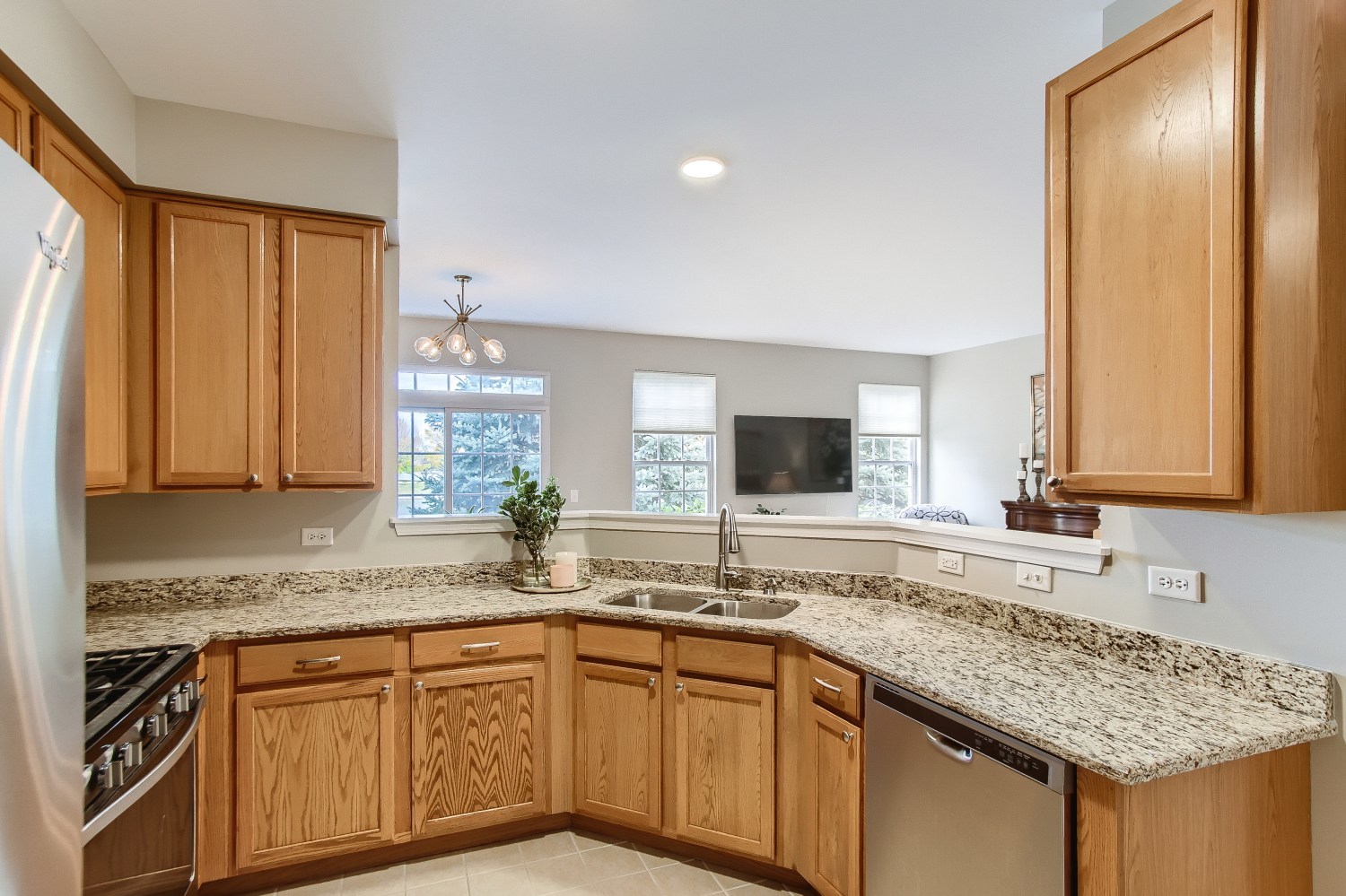 1966 West Cobblestone Road Romeoville, IL 60446 - Photo 8 of 31 a kitchen with granite countertop stainless steel appliances a sink stove and cabinets