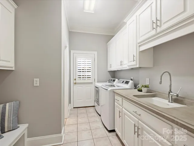 a view of a kitchen with sink dryer and washer