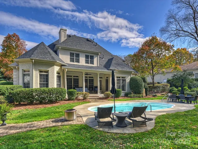 a view of a house with garden and a tree