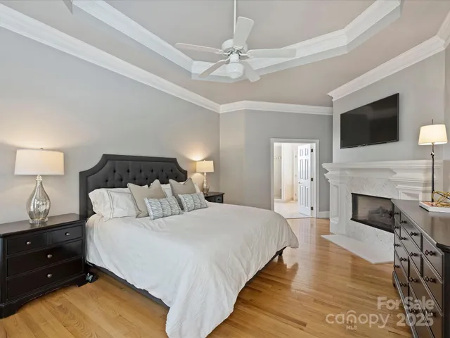 a spacious bedroom with a bed and a fireplace