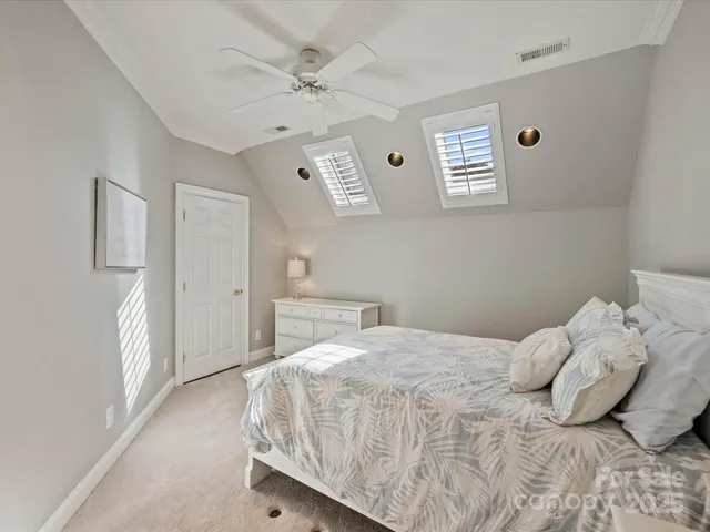 a bedroom with a bed and cabinets