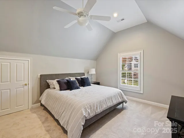 a bedroom with a large bed and a window