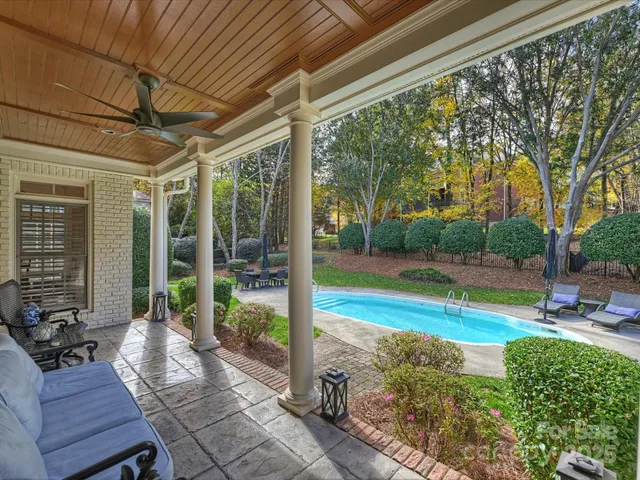 a view of a porch with couches chairs and table