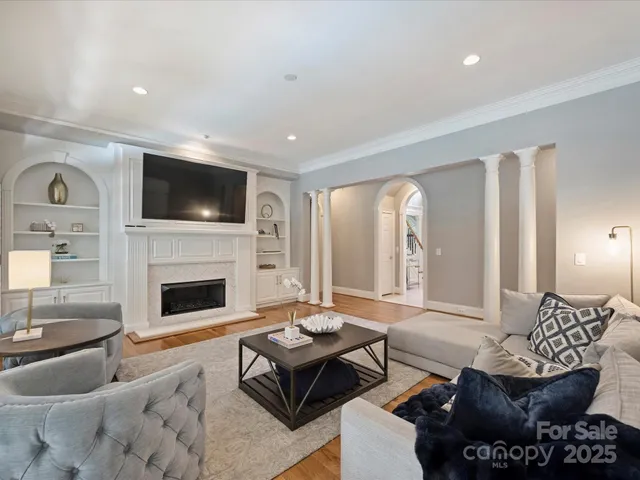 a living room with furniture fireplace and a flat screen tv