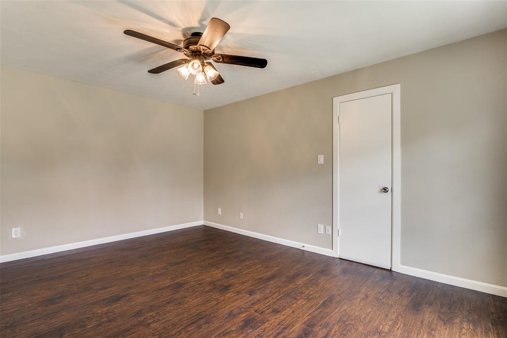 4430 Chapman Street The Colony, TX 75056 - Photo 12 of 24 a view of an empty room with wooden floor