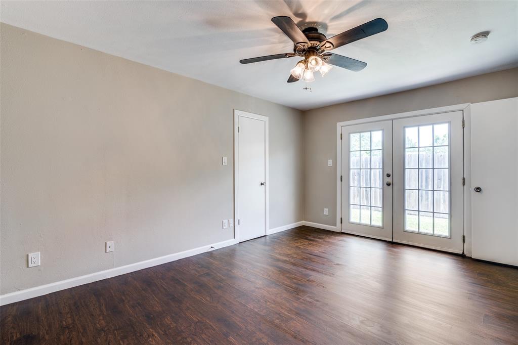 4430 Chapman Street The Colony, TX 75056 - Photo 13 of 24 an empty room with wooden floor and windows