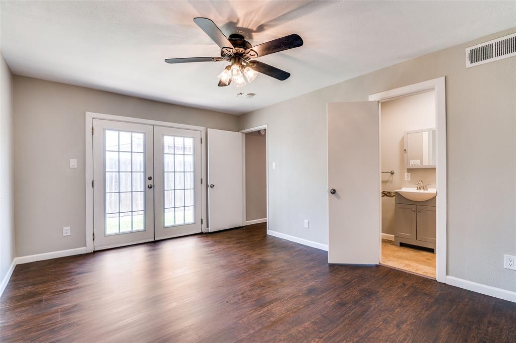 4430 Chapman Street The Colony, TX 75056 - Photo 14 of 24 a view of an empty room with a window and wooden floor