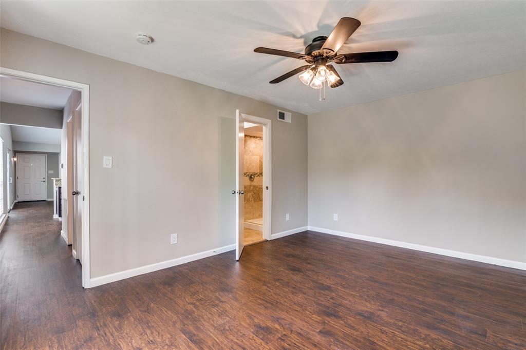 4430 Chapman Street The Colony, TX 75056 - Photo 15 of 24 a view of an empty room with wooden floor and a ceiling fan