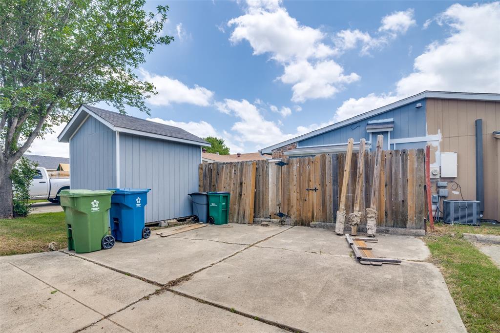 4430 Chapman Street The Colony, TX 75056 - Photo 24 of 24 a view of a backyard with potted plants and a large tree