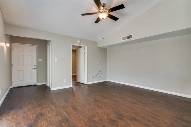 a view of an empty room and wooden floor