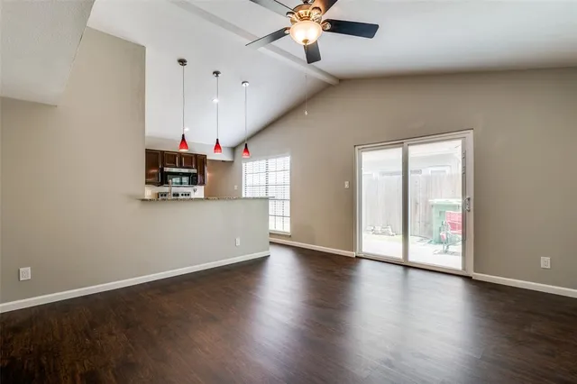 a view of a kitchen with wooden floor and a ceiling fan