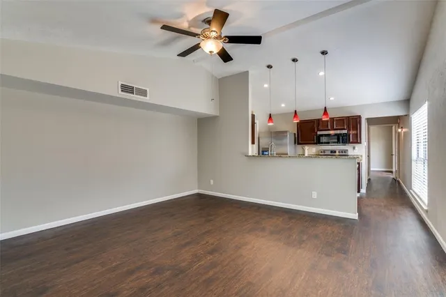 a view of kitchen with cabinets and wooden floor