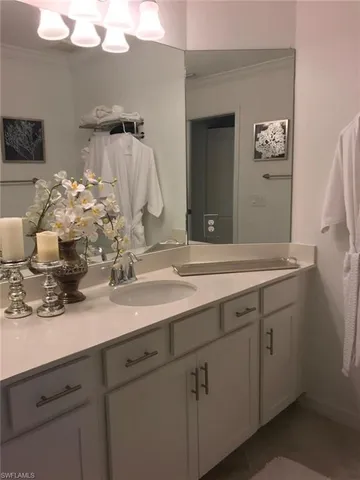 an aerial view of a swimming pool with outdoor seating and lots of green space