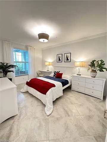 a spacious bedroom with a bed and window