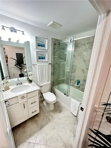 a bathroom with a double vanity sink toilet and shower