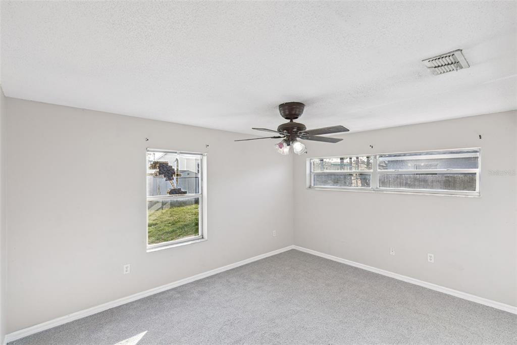 21 Cayman Circle Umatilla, FL 32784 - Photo 11 of 21 en empty room with windows and ceiling fan