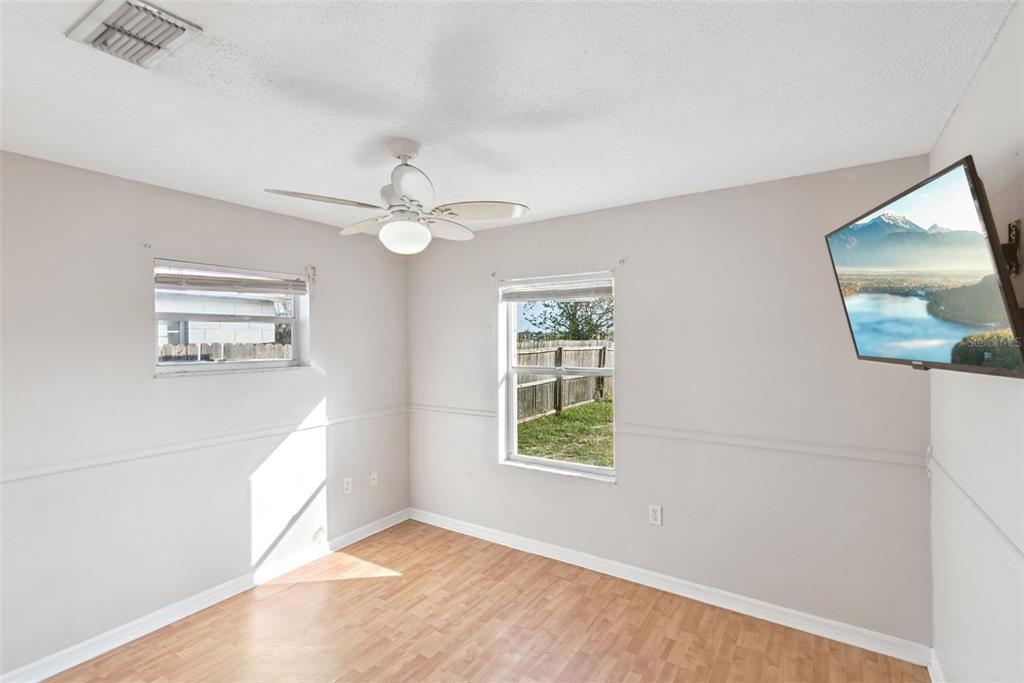 21 Cayman Circle Umatilla, FL 32784 - Photo 17 of 21 a view of an empty room with window and wooden floor
