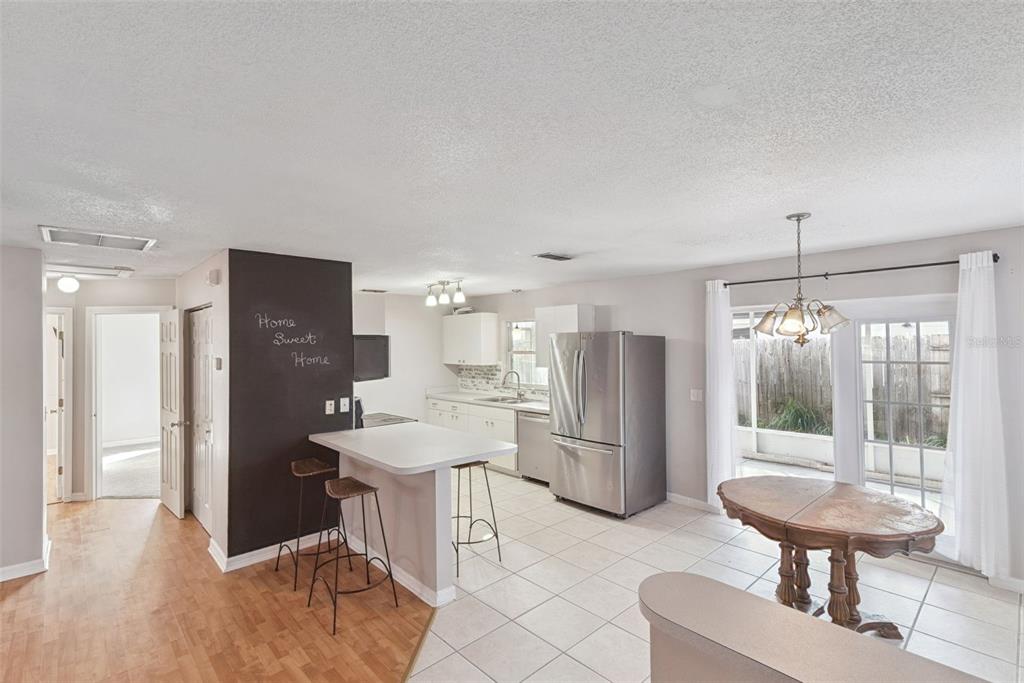 21 Cayman Circle Umatilla, FL 32784 - Photo 4 of 21 a kitchen with refrigerator and chairs