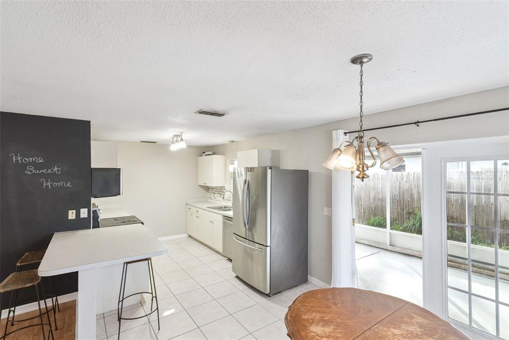 21 Cayman Circle Umatilla, FL 32784 - Photo 5 of 21 a kitchen with refrigerator and window