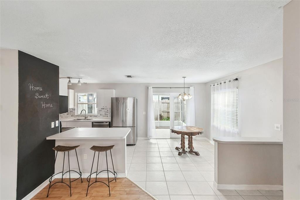 21 Cayman Circle Umatilla, FL 32784 - Photo 8 of 21 a room with two chairs and a view of kitchen appliances