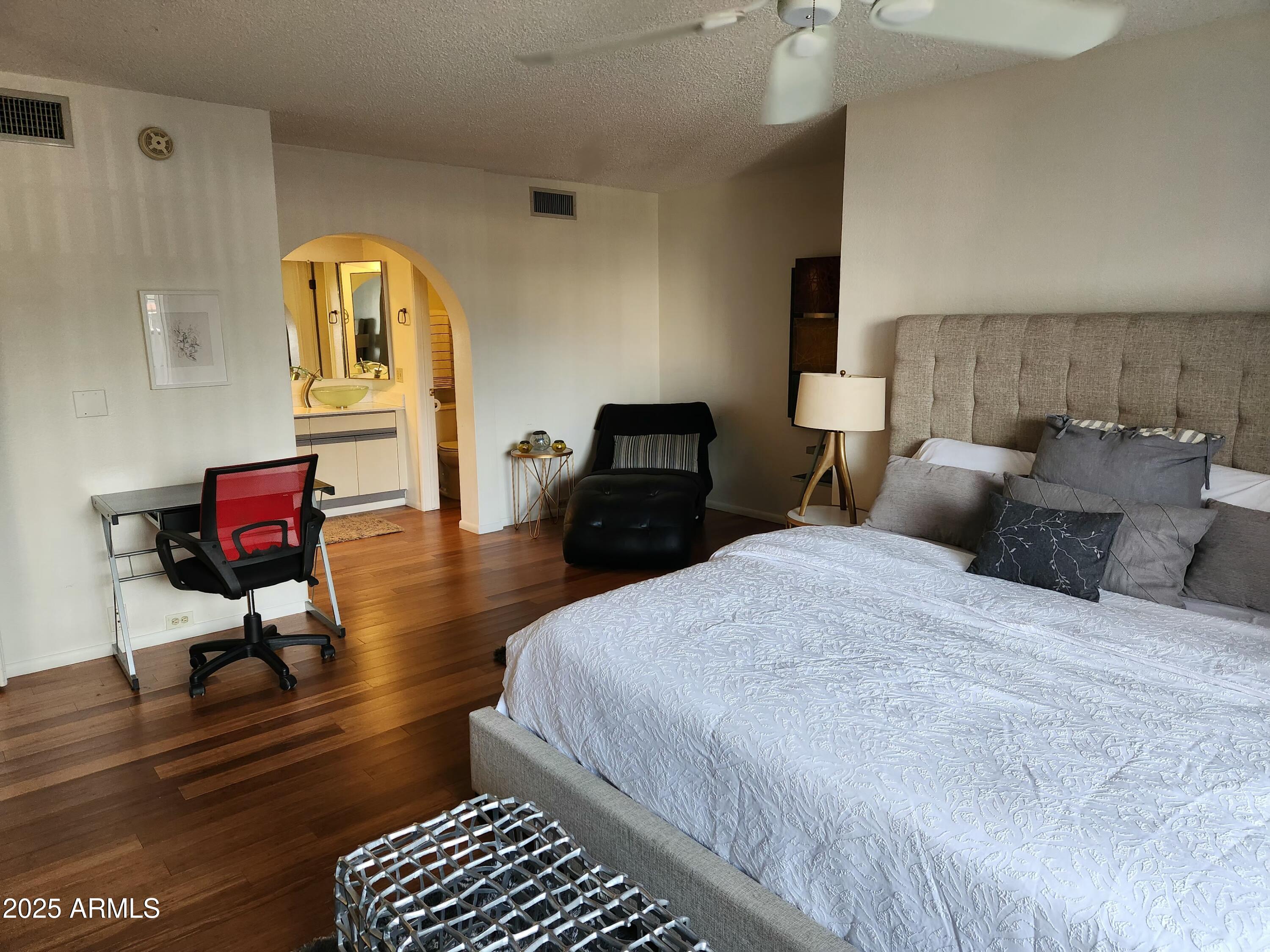 7557 North Dreamy Draw Drive, Unit 184 Phoenix, AZ 85020 - Photo 14 of 28 a bedroom with a bed a table and chair