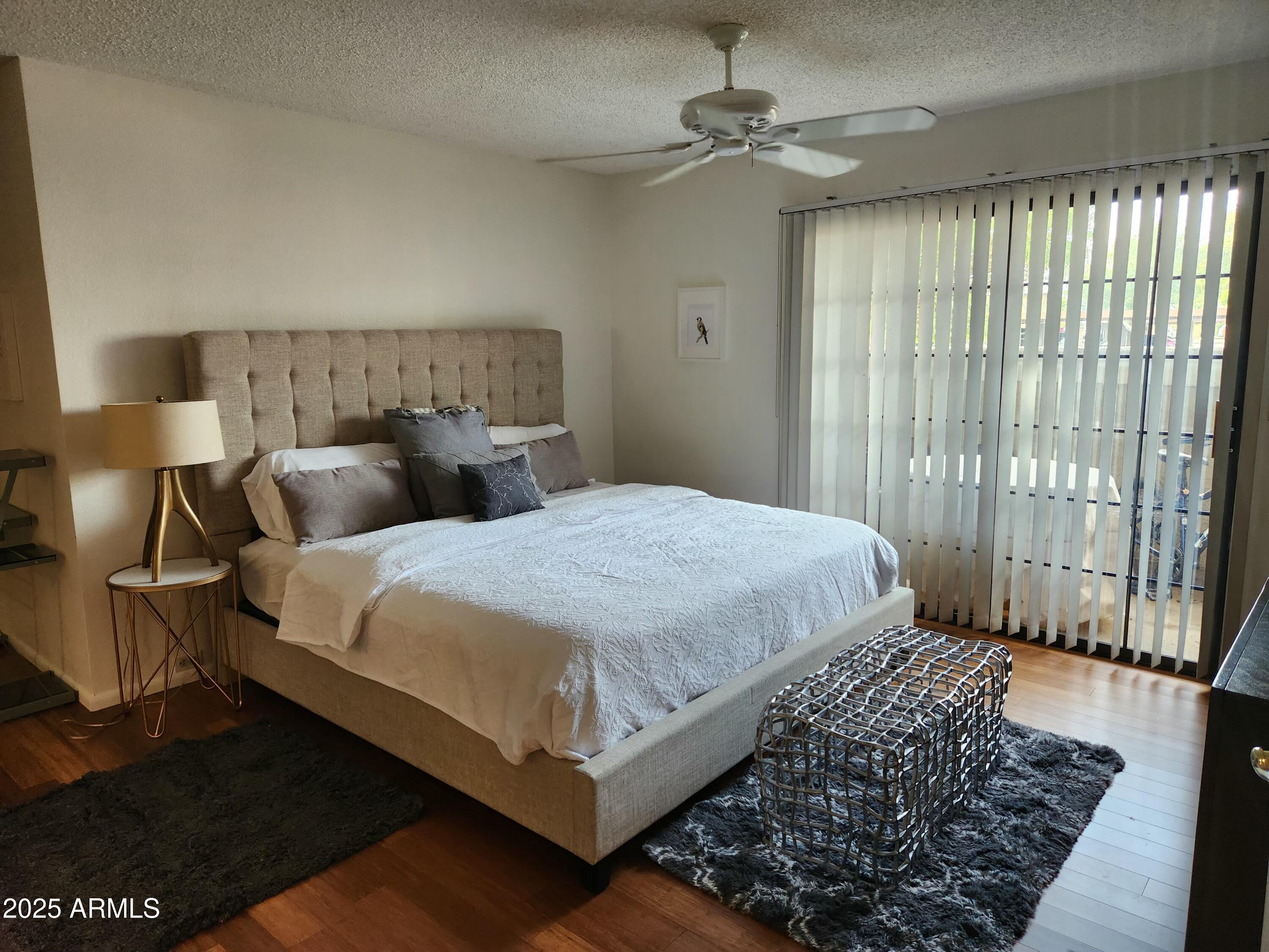 7557 North Dreamy Draw Drive, Unit 184 Phoenix, AZ 85020 - Photo 15 of 28 a bedroom with a bed rug and window