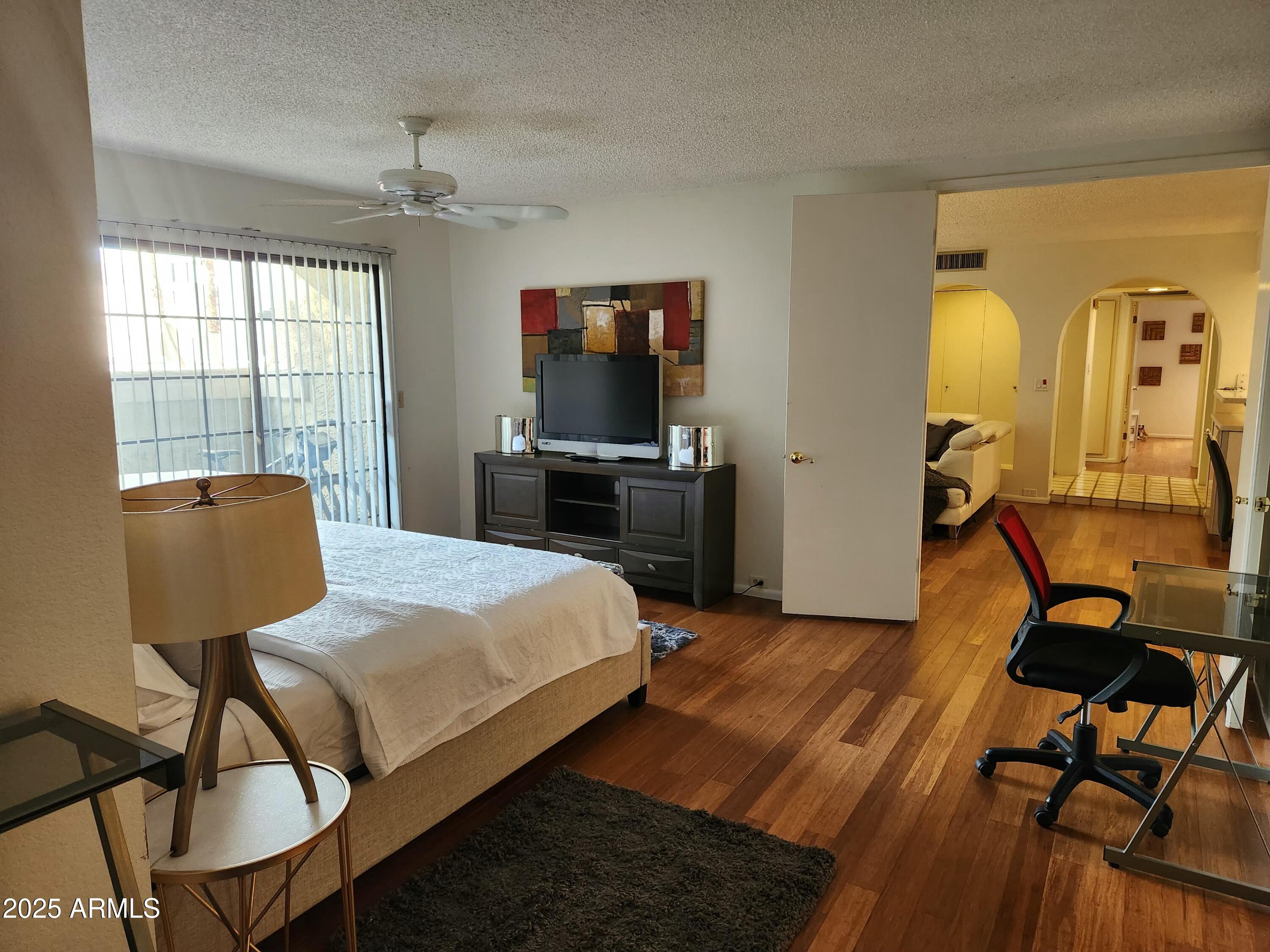 7557 North Dreamy Draw Drive, Unit 184 Phoenix, AZ 85020 - Photo 17 of 28 a bedroom with a bed and wooden floor