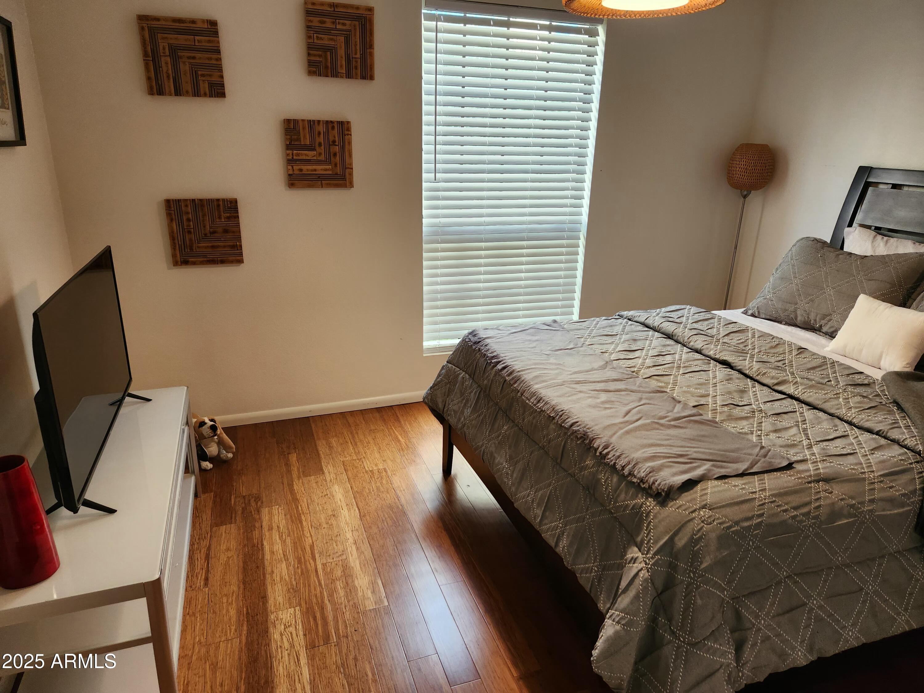 7557 North Dreamy Draw Drive, Unit 184 Phoenix, AZ 85020 - Photo 20 of 28 a bedroom with a bed and a flat tv screen on a dresser