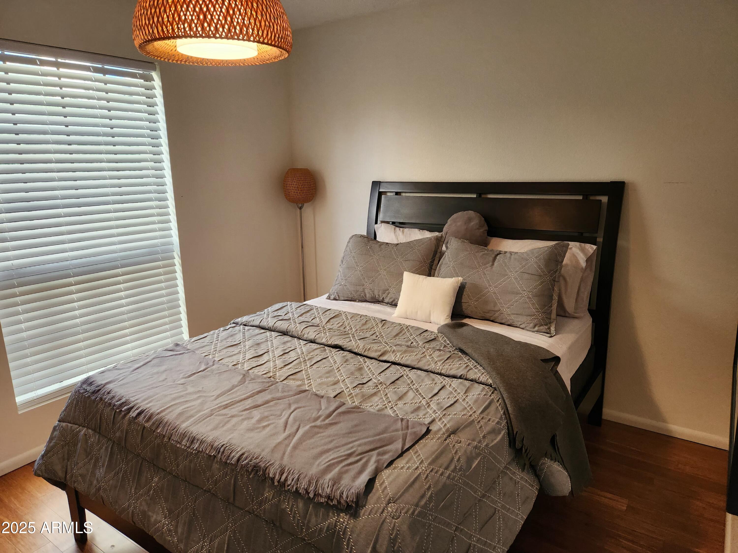 7557 North Dreamy Draw Drive, Unit 184 Phoenix, AZ 85020 - Photo 21 of 28 a large bed sitting in a bedroom next to a window