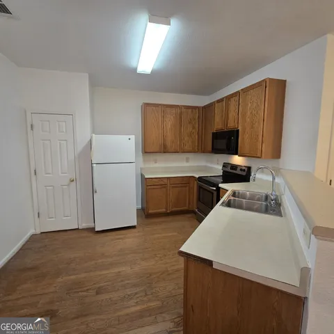 a kitchen with a cabinets and white appliances