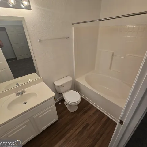 a bathroom with a sink a toilet and a bathtub