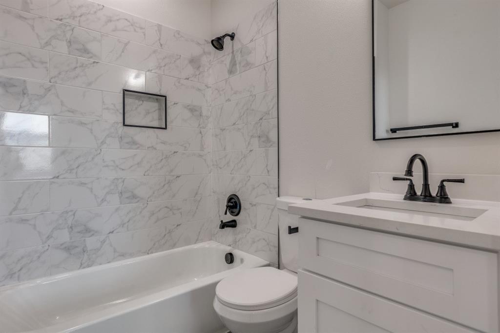 2427 Merlin Street Dallas, TX 75215 - Photo 15 of 24 a bathroom with a sink a toilet and shower
