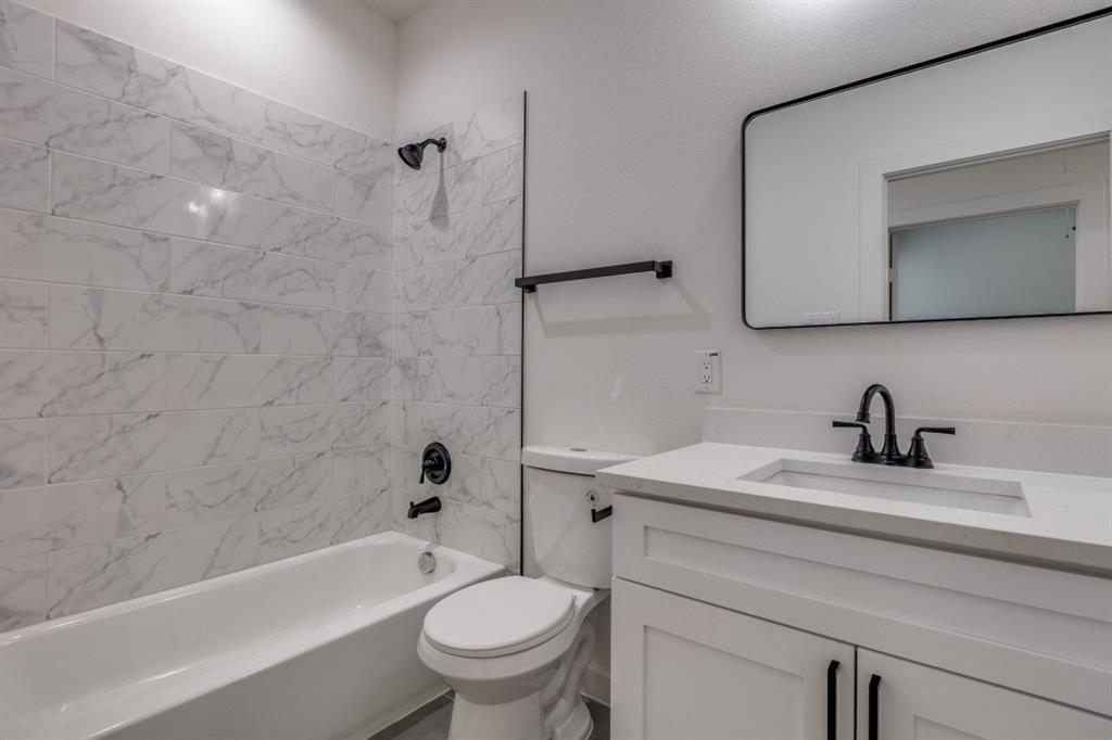 2427 Merlin Street Dallas, TX 75215 - Photo 20 of 24 a bathroom with a sink a toilet and a bathtub