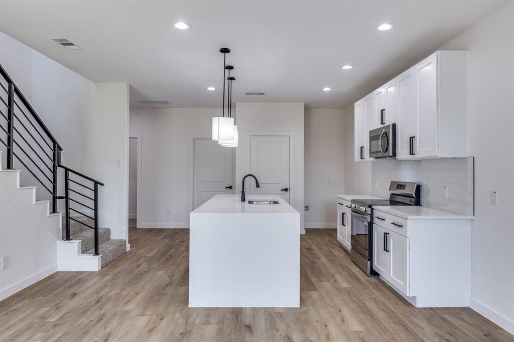 2427 Merlin Street Dallas, TX 75215 - Photo 8 of 24 a kitchen with stainless steel appliances a sink stove and refrigerator