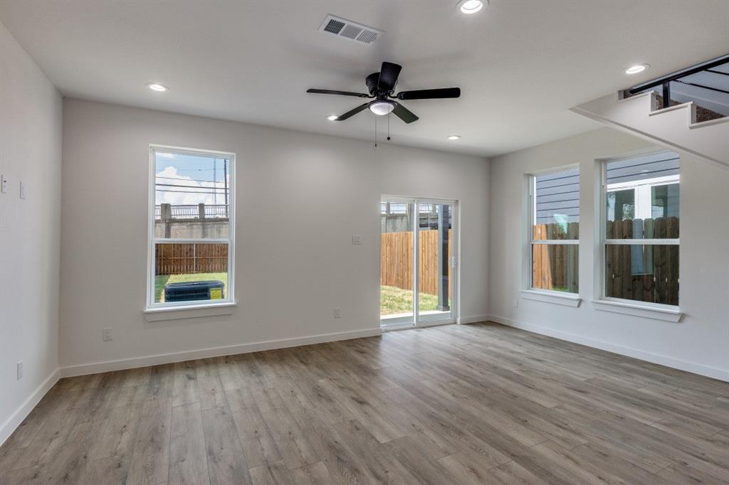 2427 Merlin Street Dallas, TX 75215 - Photo 10 of 24 a view of an empty room with wooden floor and a window
