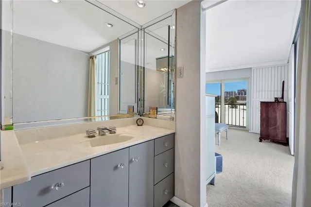 a en suite bathroom with a double vanity sink a large mirror and a shower