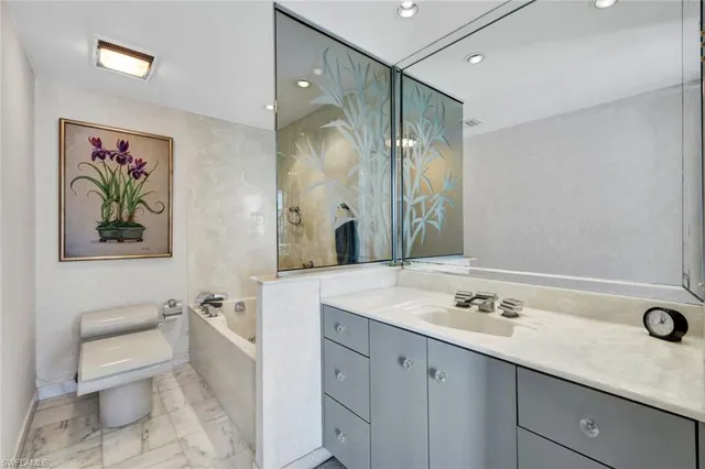 a spacious bathroom with a sink mirror vanity and toilet