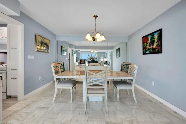 a dining room with furniture a rug and a chandelier