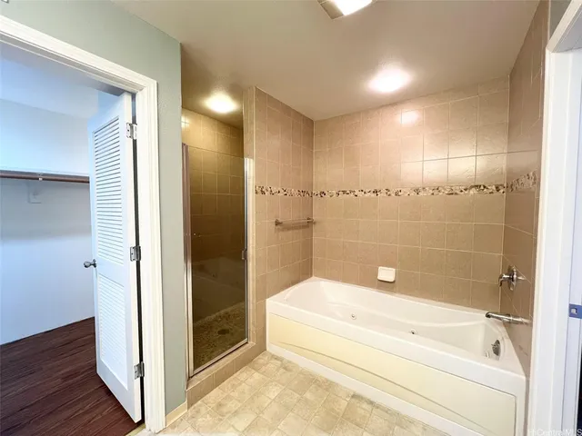 a spacious bathroom with a tub and shower