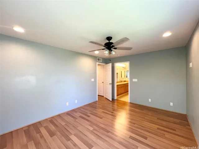 a view of an empty room and wooden floor
