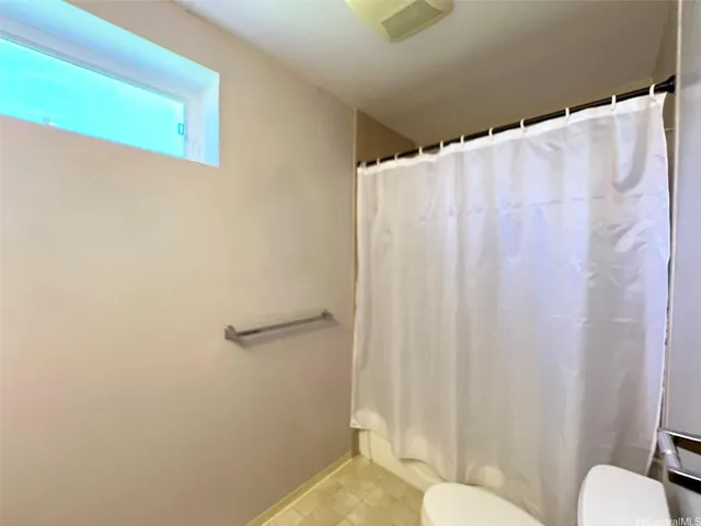 a bathroom with a shower curtain and sink