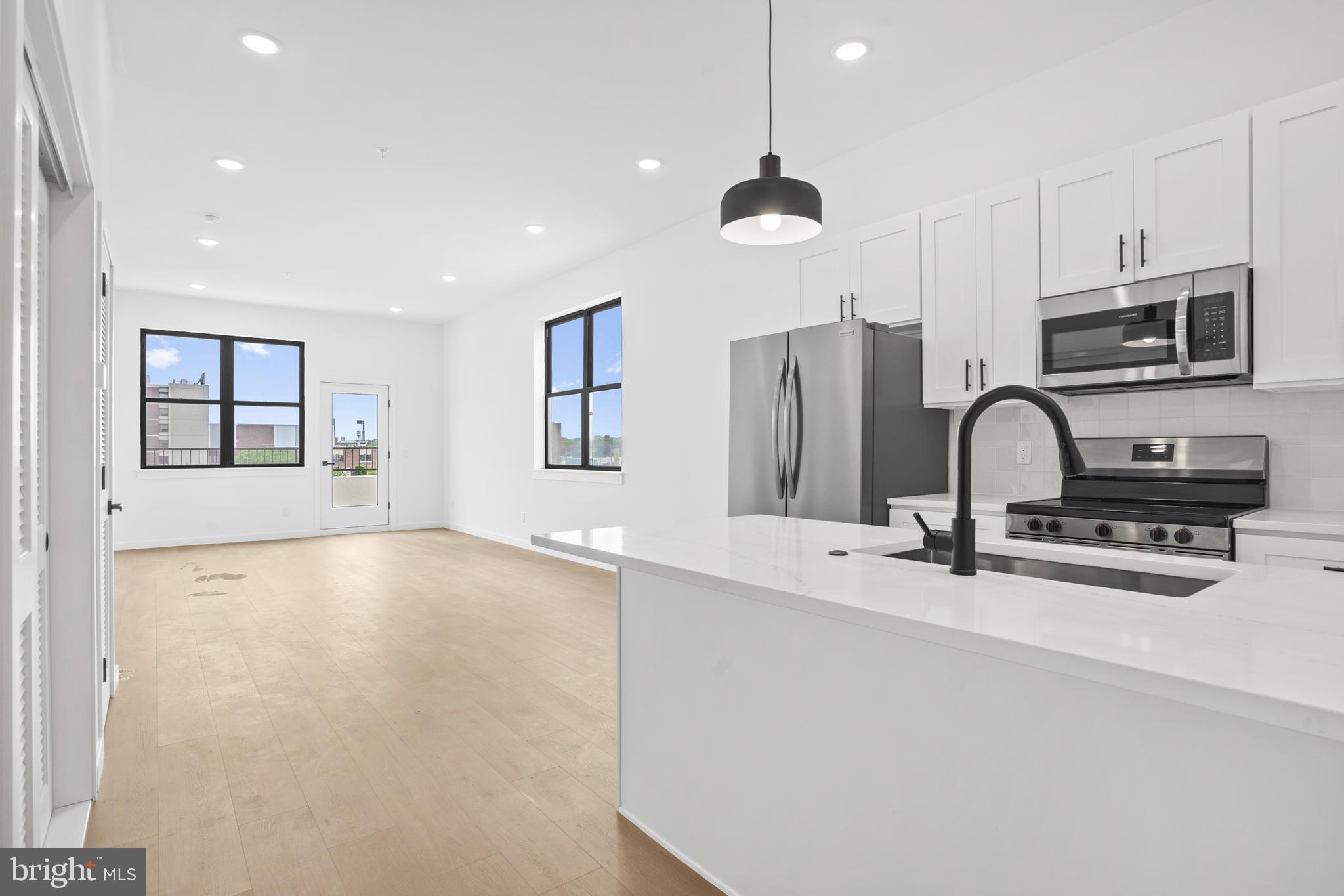 3211 Cedar Street, Unit 306 Philadelphia, PA 19134 - Photo 1 of 18 a view of a kitchen with a sink and dishwasher