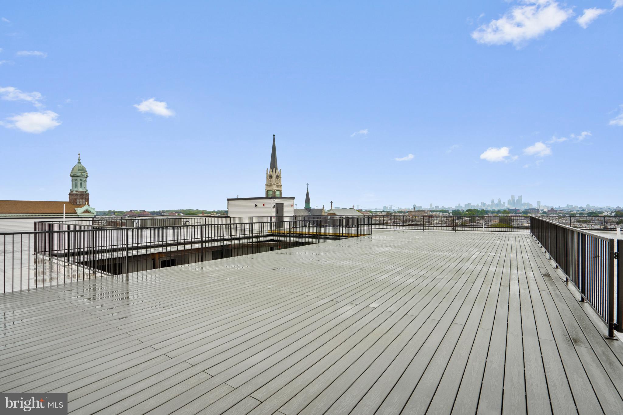 3211 Cedar Street, Unit 306 Philadelphia, PA 19134 - Photo 14 of 18 a view of a terrace with wooden floor and seating space
