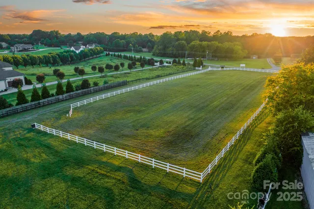 a view of a field with mountains in the background