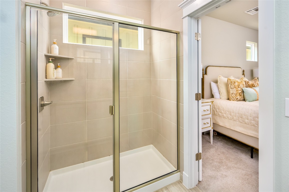 142 Volterra Lane Dripping Springs, TX 78620 - Photo 12 of 37 a bathroom with a tub and shower
