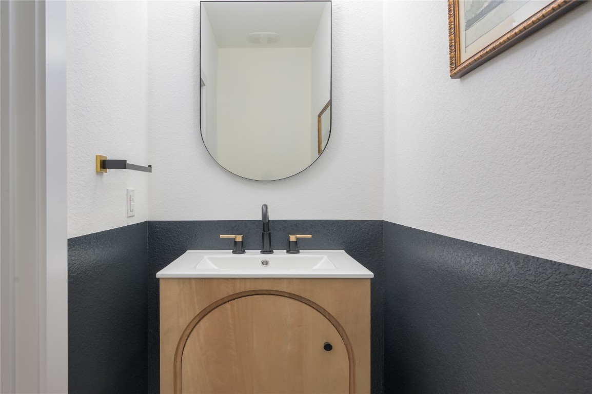 142 Volterra Lane Dripping Springs, TX 78620 - Photo 13 of 37 a bathroom with a sink and a mirror