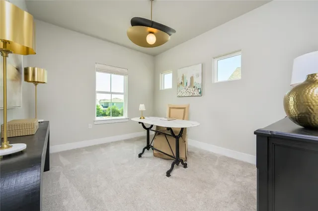 a view of a workspace with furniture and a window