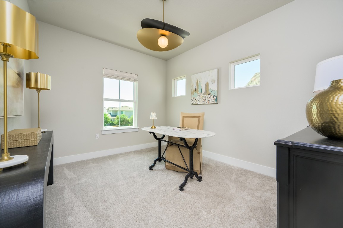 142 Volterra Lane Dripping Springs, TX 78620 - Photo 15 of 37 a view of a workspace with furniture and a window