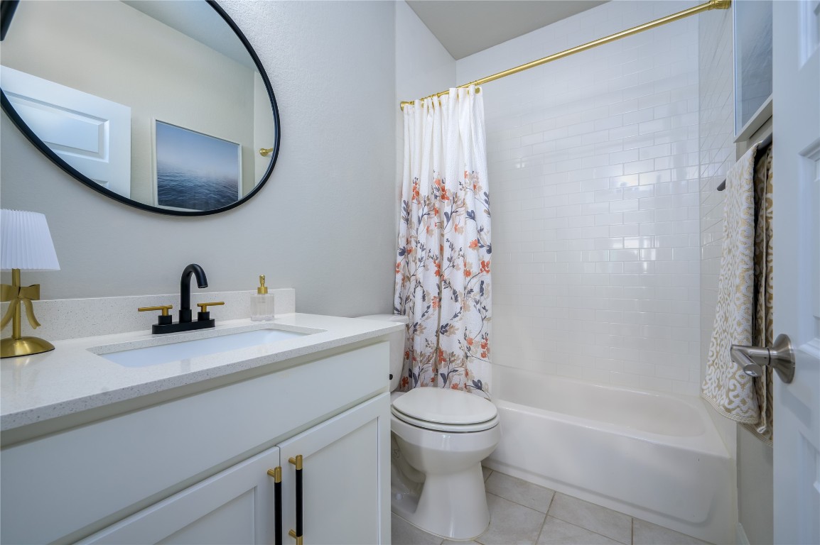 142 Volterra Lane Dripping Springs, TX 78620 - Photo 20 of 37 a bathroom with a sink a toilet and a mirror